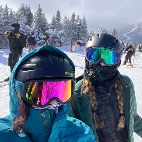 Two people in ski gear on a snowy mountain
