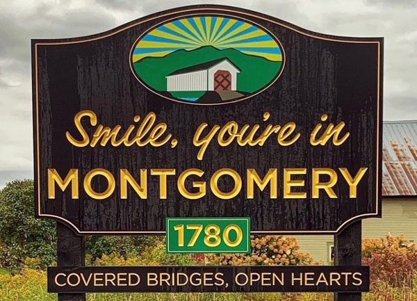 Photo of a brown sign that says "Smile, you're in Montgomery"